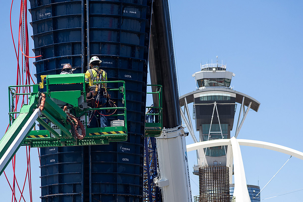 Workers install column forms into which concrete will be placed at East Central Terminal Station.