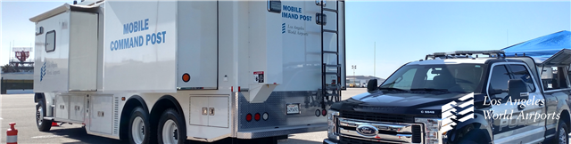 Image of a mobile command post and a police truck.