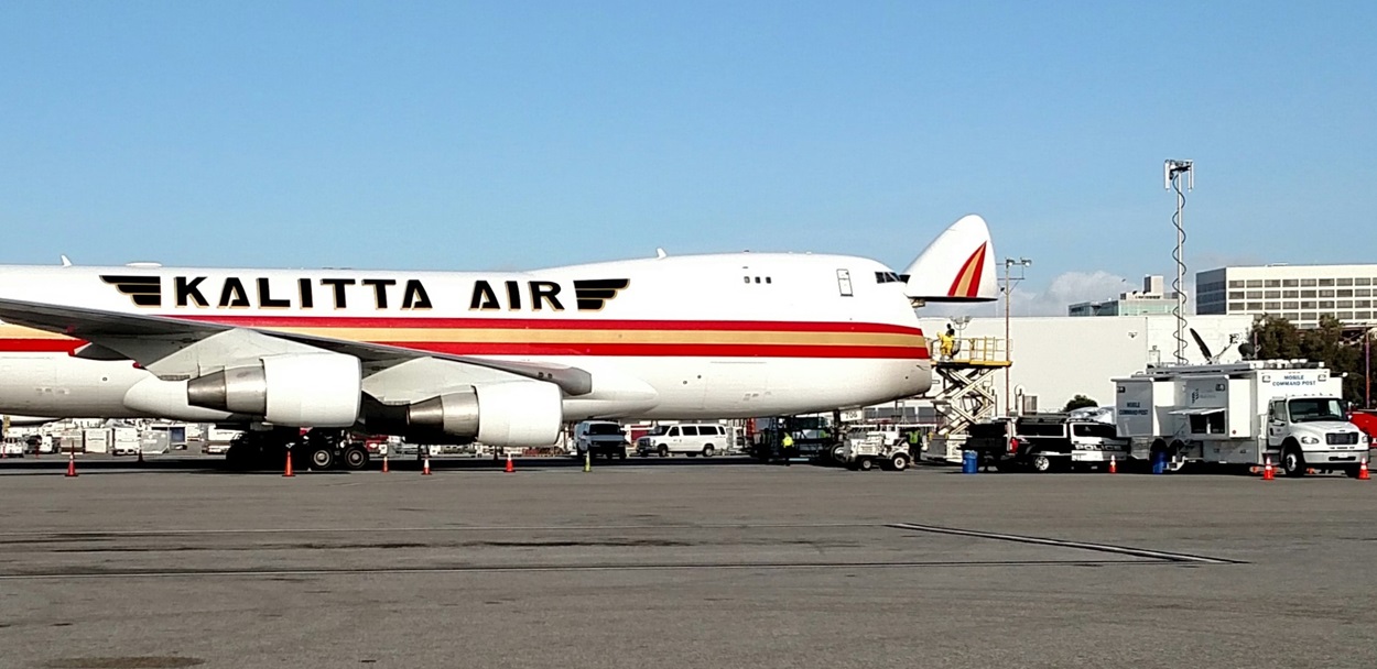 Image of an Kalitta Air airplane with its nose open for inspection. 