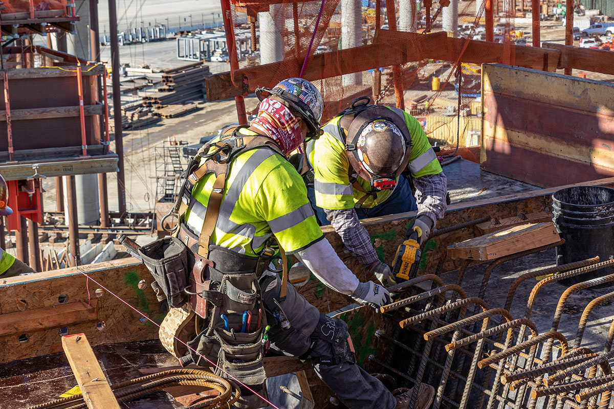 Workers install rebar