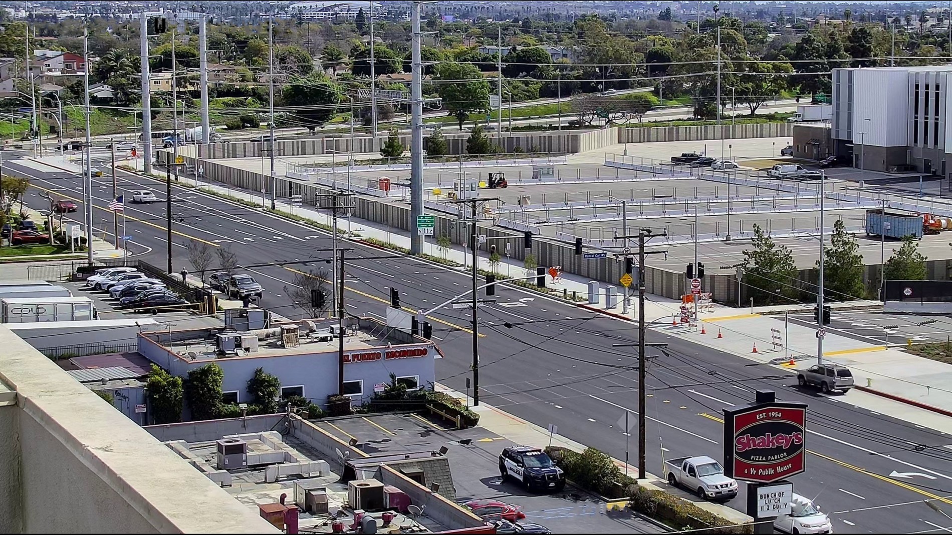 View looking east on Arbor Vitae Street showing street widening alongside the northern and eastern edges of Consolidated Rent-A-Car facility property.